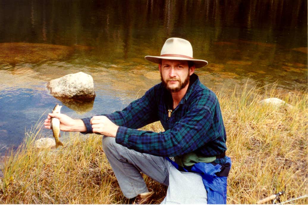 Here I am with one of my catches. Eventually the sun came out and spoiled our fun. We decided to stash the fishing gear and walk the rest of the way up to the cirque.